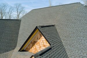 a clean and restored asphalt shingle roof on residential home